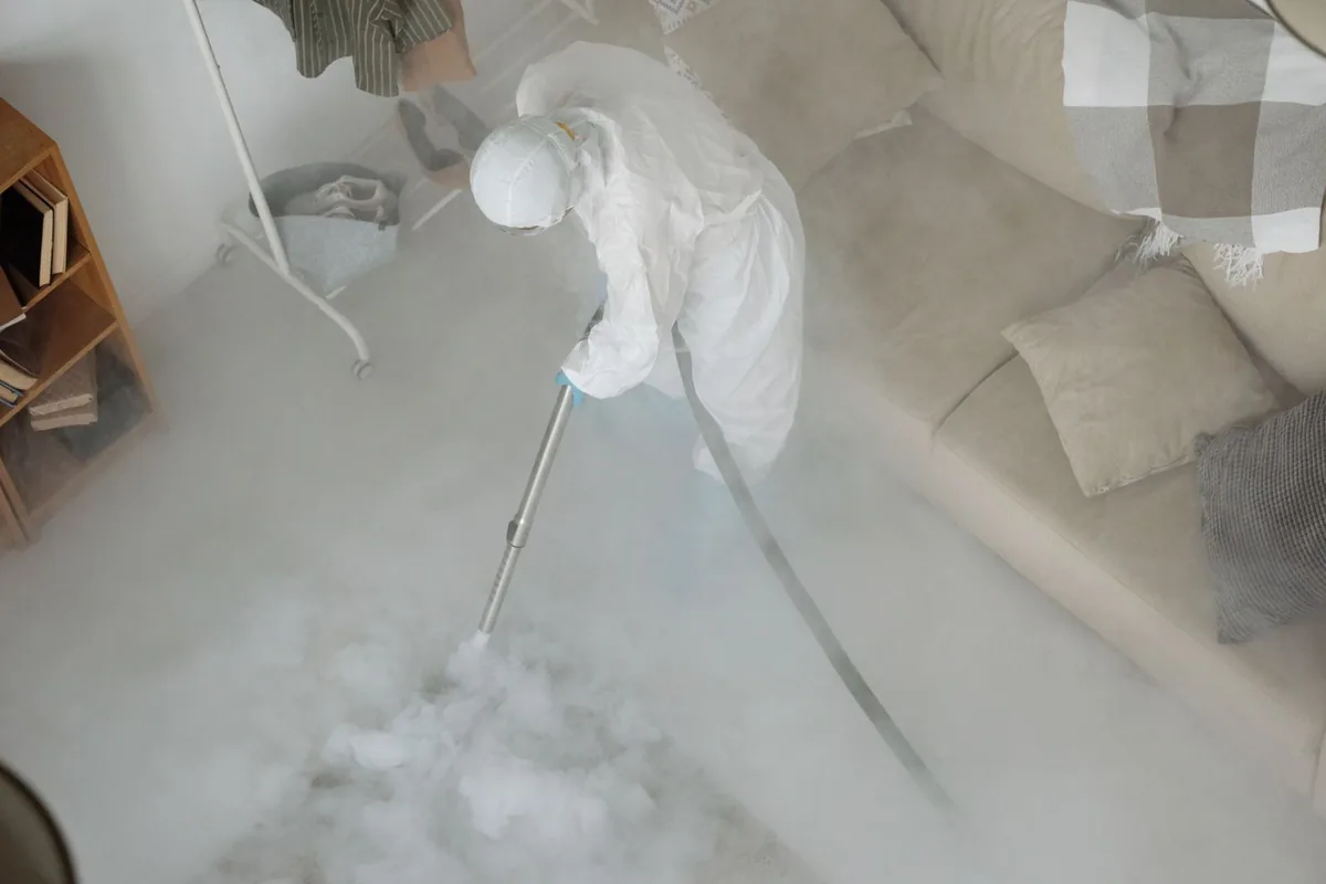 Biohazard cleanup technician in protective equipment, Newton, TX